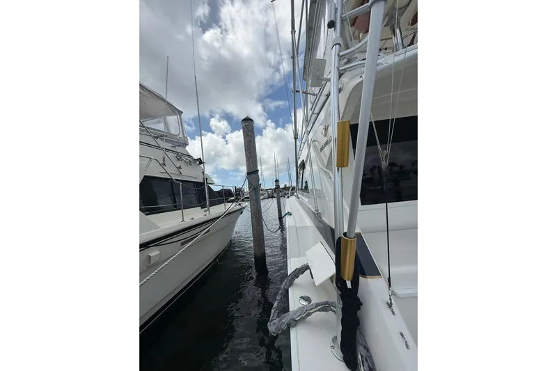  Yacht Photos Pics 1988 Bertram 43 Flybridge yacht docked, showcasing sleek design and sturdy build.
