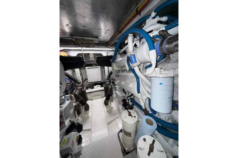  Yacht Photos Pics Engine room of 1988 Bertram 43 Flybridge with visible pipes and machinery.