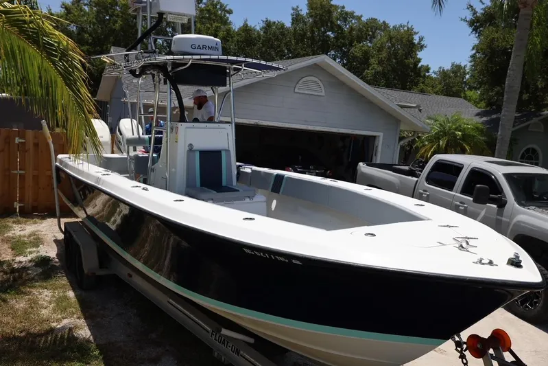 Late Fees Yacht Photos Pics 2001 Contender 27 Open boat on trailer in driveway.