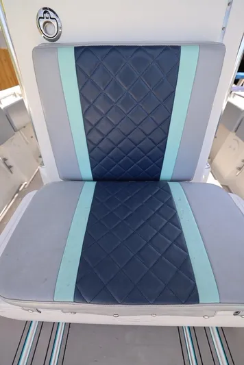 Late Fees Yacht Photos Pics Contender 27 Open 2001 boat seat with blue and teal diamond-pattern upholstery.