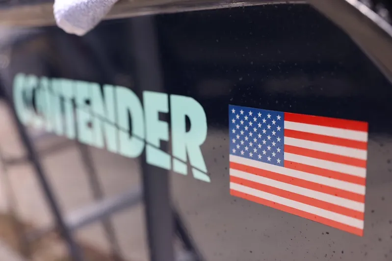 Late Fees Yacht Photos Pics Close-up of 2001 Contender 27 Open boat with American flag decal.