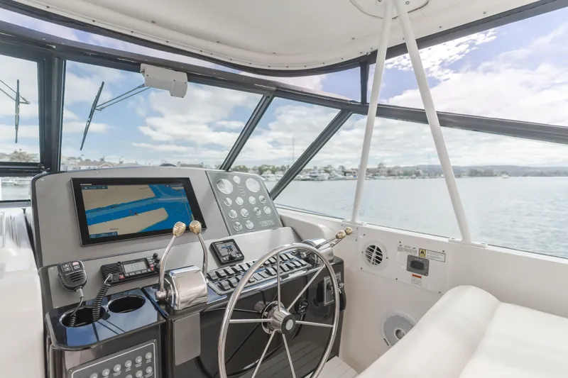 Half Dozen Yacht Photos Pics 2001 Tiara Yachts 4100 Open helm with navigation system and scenic water view.