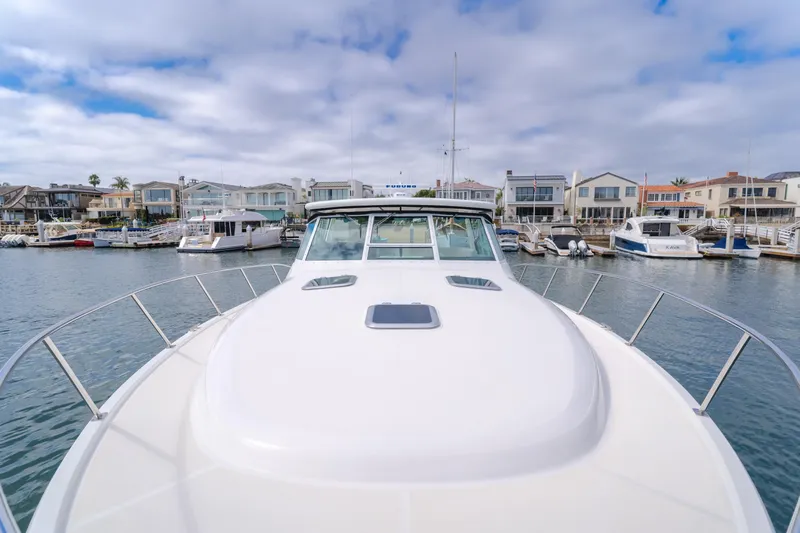 Half Dozen Yacht Photos Pics 2001 Tiara Yachts 4100 Open docked in a marina with waterfront homes.