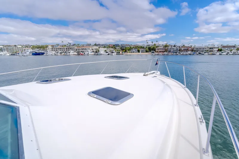 Half Dozen Yacht Photos Pics 2001 Tiara Yachts 4100 Open cruising in a scenic harbor with waterfront homes.