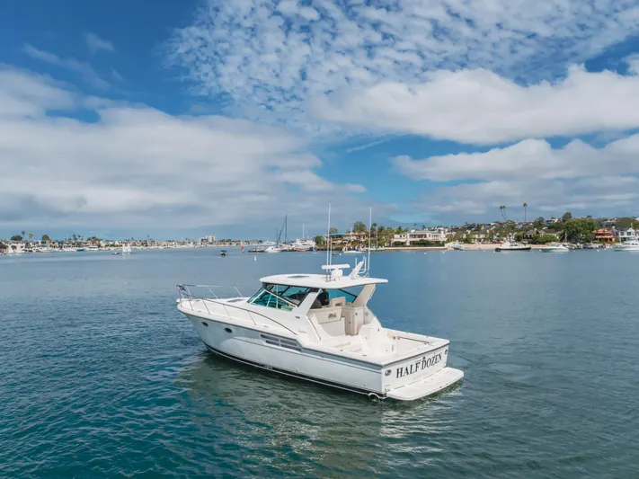 Half Dozen Yacht Photos Pics 2001 Tiara Yachts 4100 Open on calm water under a partly cloudy sky.