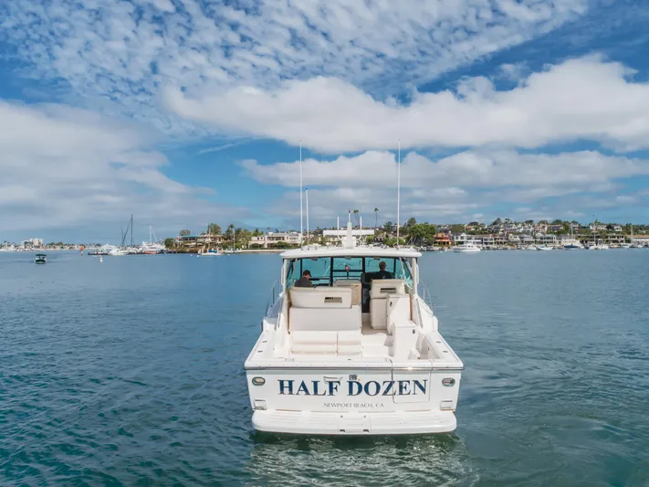 Half Dozen Yacht Photos Pics 2001 Tiara Yachts 4100 Open cruising in scenic harbor with clear skies.