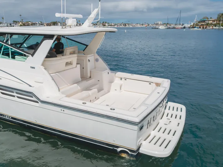 Half Dozen Yacht Photos Pics 2001 Tiara Yachts 4100 Open on calm water, featuring spacious deck and sleek design.