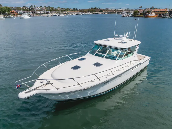 Half Dozen Yacht Photos Pics 2001 Tiara Yachts 4100 Open cruising on a calm waterway.