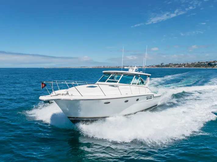 Half Dozen Yacht Photos Pics 2001 Tiara Yachts 4100 Open cruising on blue ocean under clear sky.