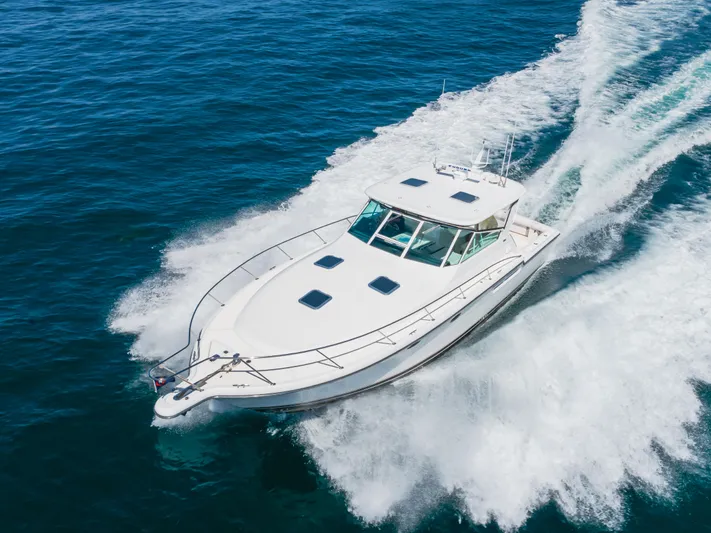 Half Dozen Yacht Photos Pics 2001 Tiara Yachts 4100 Open cruising on open water, creating a dynamic wake.