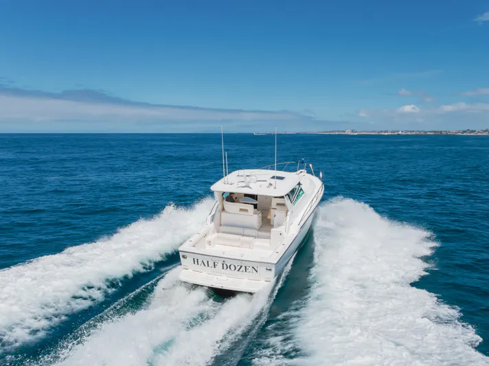 Half Dozen Yacht Photos Pics 2001 Tiara Yachts 4100 Open cruising on open sea, clear blue sky.