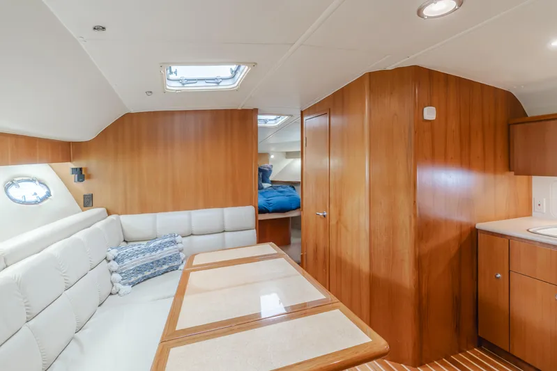 Half Dozen Yacht Photos Pics Interior of 2001 Tiara Yachts 4100 Open, featuring wood paneling and a cozy seating area.