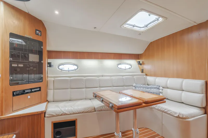 Half Dozen Yacht Photos Pics Interior of 2001 Tiara Yachts 4100 Open with plush seating and wooden accents.