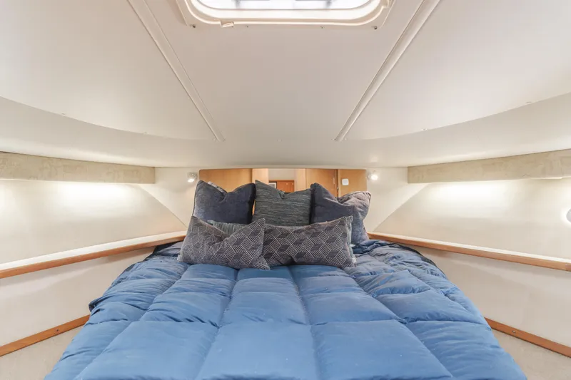 Half Dozen Yacht Photos Pics Luxurious cabin interior of 2001 Tiara Yachts 4100 Open with cozy bedding.