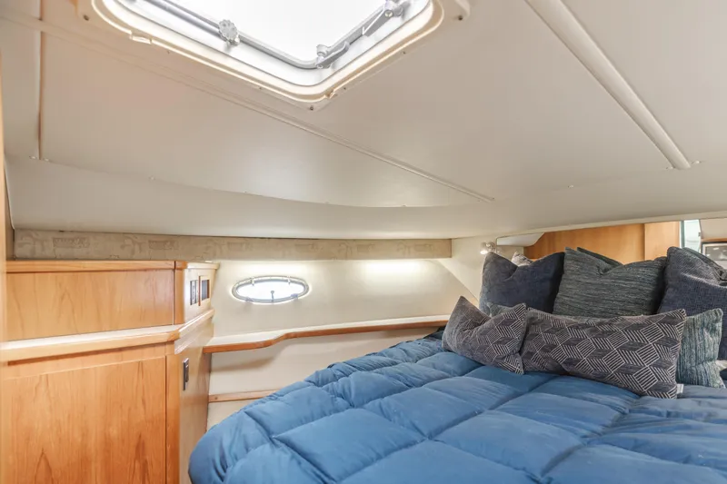 Half Dozen Yacht Photos Pics Cozy cabin interior of 2001 Tiara Yachts 4100 Open with plush bedding and natural light.
