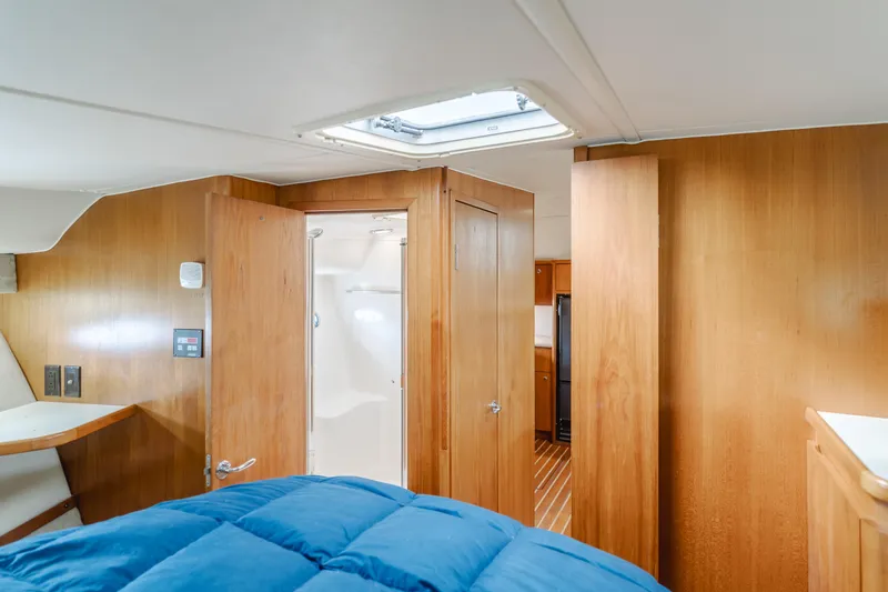 Half Dozen Yacht Photos Pics Interior of 2001 Tiara Yachts 4100 Open, featuring wood paneling and a cozy cabin space.