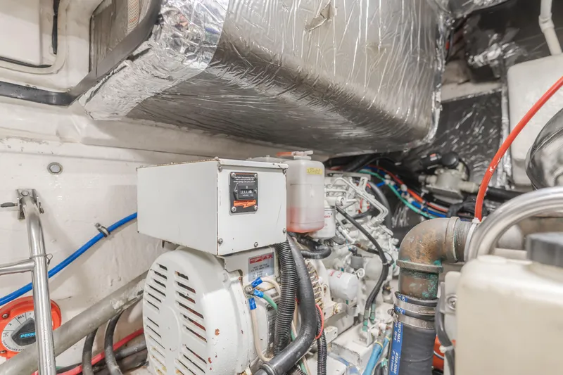 Half Dozen Yacht Photos Pics Engine room of 2001 Tiara Yachts 4100 Open, showcasing mechanical components and wiring.