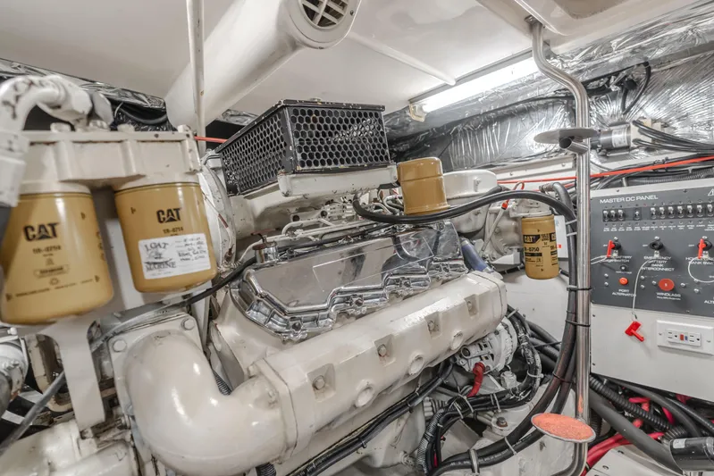 Half Dozen Yacht Photos Pics Engine room of a 2001 Tiara Yachts 4100 Open, featuring CAT filters and control panel.