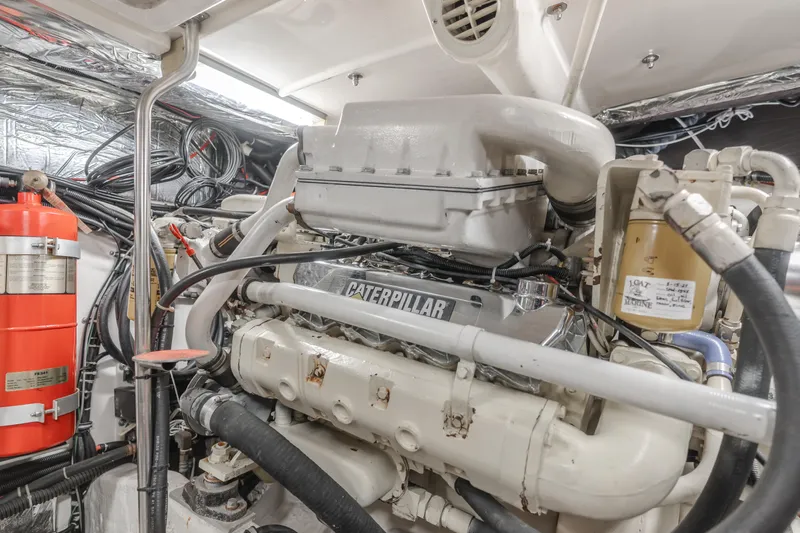 Half Dozen Yacht Photos Pics Engine room of 2001 Tiara Yachts 4100 Open with Caterpillar engine and fire extinguisher.