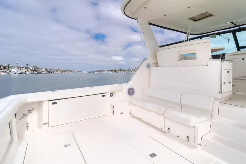 Half Dozen Yacht Photos Pics 2001 Tiara Yachts 4100 Open with spacious deck and seating, overlooking a serene waterfront.