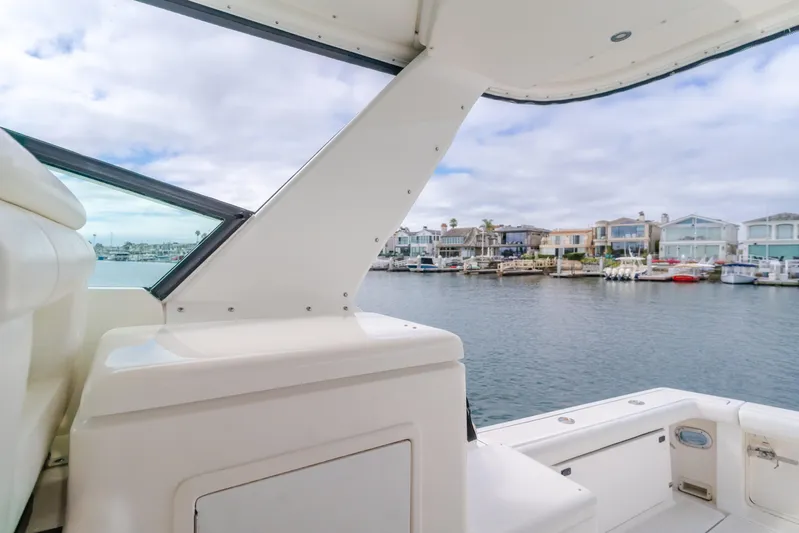 Half Dozen Yacht Photos Pics 2001 Tiara Yachts 4100 Open, docked with waterfront homes in the background.