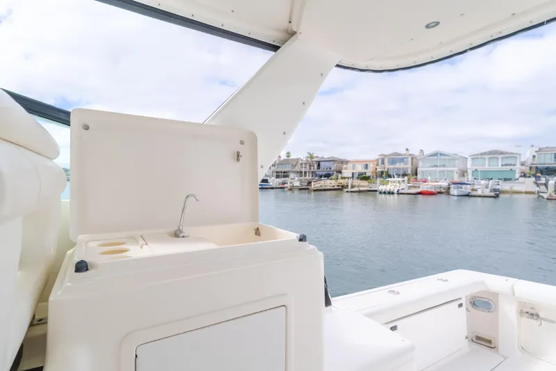 Half Dozen Yacht Photos Pics 2001 Tiara Yachts 4100 Open with sink, overlooking marina and waterfront homes.