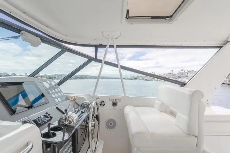 Half Dozen Yacht Photos Pics Interior view of 2001 Tiara Yachts 4100 Open, featuring helm and seating area.