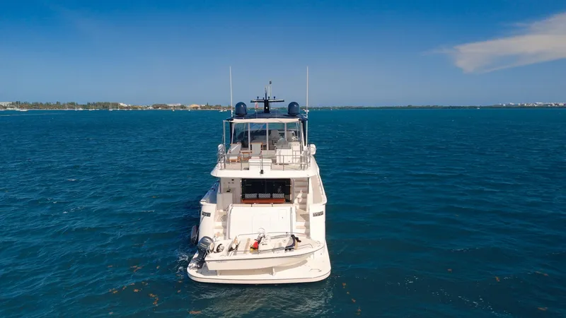  Yacht Photos Pics 2017 Hatteras M75 Panacera yacht on open blue sea, rear view.