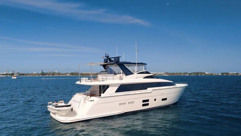  Yacht Photos Pics 2017 Hatteras M75 Panacera yacht cruising on open water under clear blue skies.
