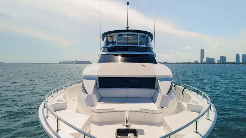  Yacht Photos Pics 2017 Hatteras M75 Panacera yacht cruising on open water with city skyline in background.