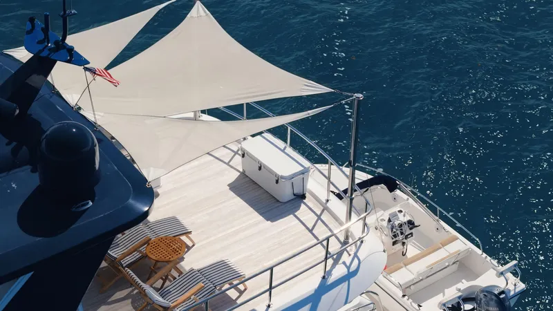  Yacht Photos Pics Luxurious 2017 Hatteras M75 Panacera yacht deck with sunshade, overlooking blue ocean waters.