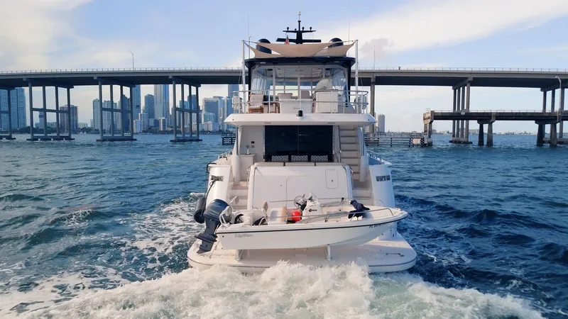  Yacht Photos Pics 2017 Hatteras M75 Panacera yacht cruising under a city bridge.