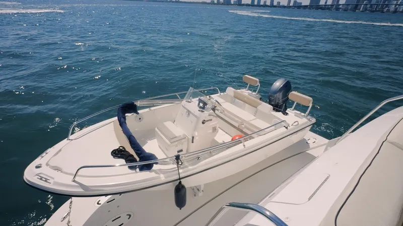  Yacht Photos Pics 2017 Hatteras M75 Panacera yacht on open water with city skyline in background.