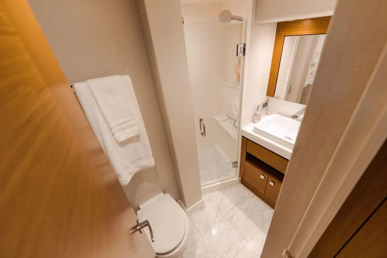  Yacht Photos Pics Luxurious bathroom in 2017 Hatteras M75 Panacera yacht with marble flooring and modern fixtures.