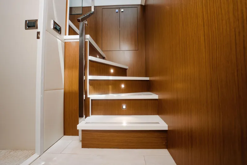  Yacht Photos Pics Staircase with wooden paneling and modern lighting on a 2017 Hatteras M75 Panacera yacht.
