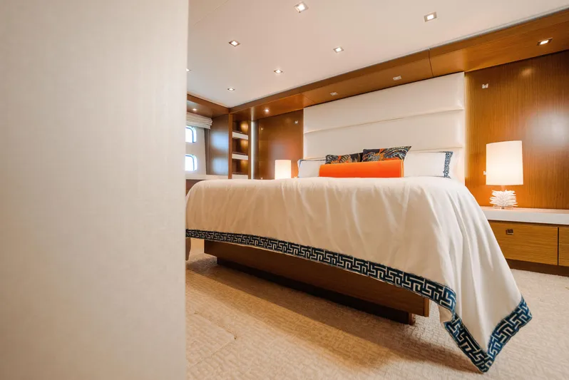  Yacht Photos Pics Luxurious bedroom interior of 2017 Hatteras M75 Panacera yacht with elegant bedding and warm lighting.