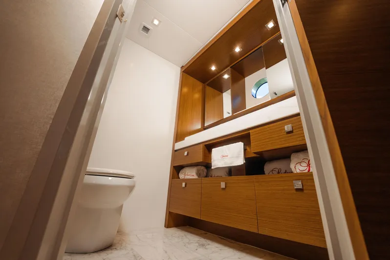  Yacht Photos Pics Luxurious bathroom interior of 2017 Hatteras M75 Panacera yacht with modern wood cabinetry.