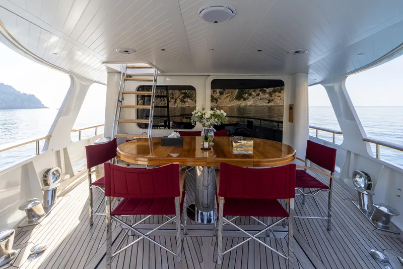  Yacht Photos Pics Luxurious 1989 Moonen 85 yacht deck with elegant dining area and ocean view.