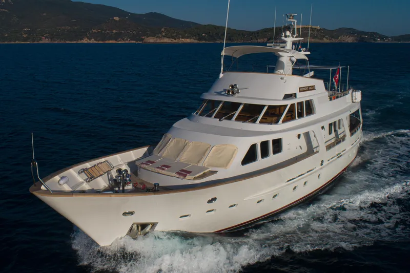  Yacht Photos Pics Luxurious 1989 Moonen 85 yacht cruising on open sea, elegant design and spacious deck.