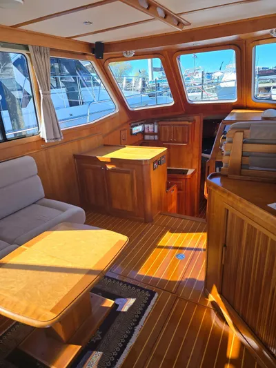 Juju Yacht Photos Pics Interior of 2004 Sabre 36 Flybridge Fast Trawler with wooden furnishings and seating area.