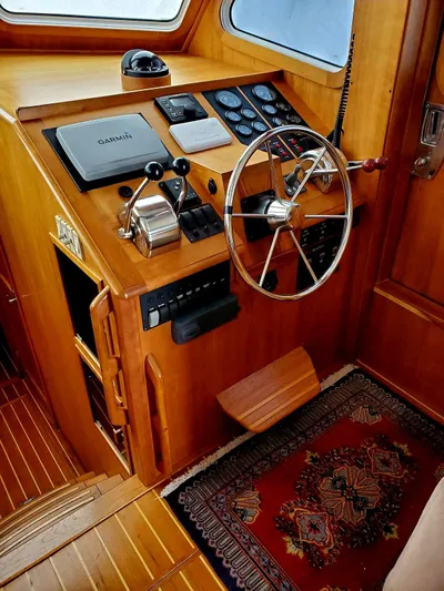 Juju Yacht Photos Pics 2004 Sabre 36 Flybridge Fast Trawler helm with wooden finish and navigation equipment.