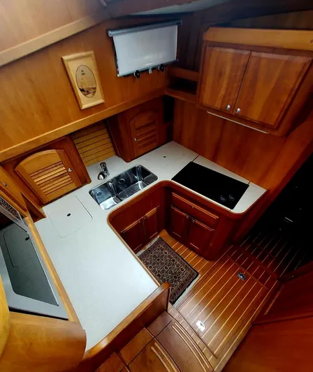 Juju Yacht Photos Pics 2004 Sabre 36 Flybridge Fast Trawler kitchen with wood cabinetry and modern appliances.