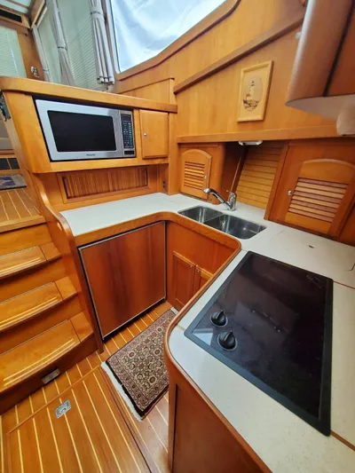 Juju Yacht Photos Pics 2004 Sabre 36 Flybridge Fast Trawler kitchen with wood cabinetry and modern appliances.