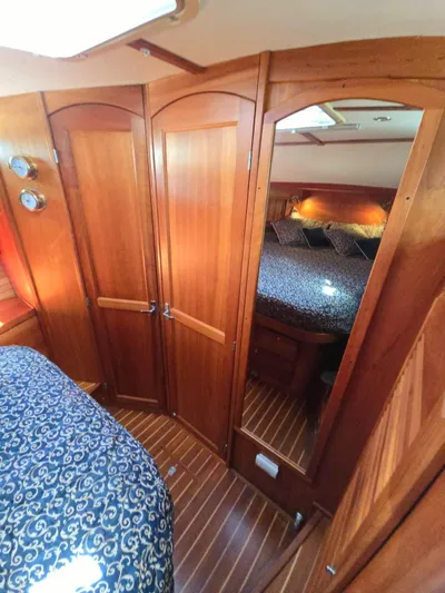 Juju Yacht Photos Pics Interior of 2004 Sabre 36 Flybridge Fast Trawler with wood paneling and cozy bedding.