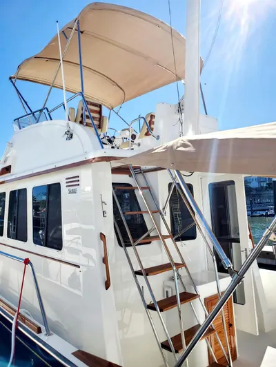 Juju Yacht Photos Pics 2004 Sabre 36 Flybridge Fast Trawler with sunshade and ladder, docked under clear skies.
