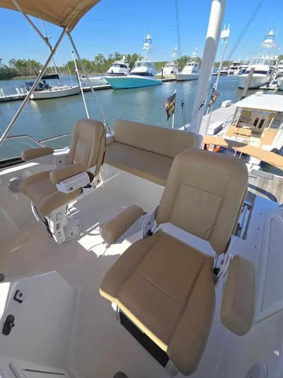Juju Yacht Photos Pics 2004 Sabre 36 Flybridge Fast Trawler with beige seating at a marina.