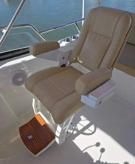 Juju Yacht Photos Pics Captain's chair on 2004 Sabre 36 Flybridge Fast Trawler, featuring beige upholstery and footrest.