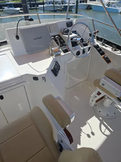 Juju Yacht Photos Pics 2004 Sabre 36 Flybridge Fast Trawler helm with steering wheel and navigation equipment.