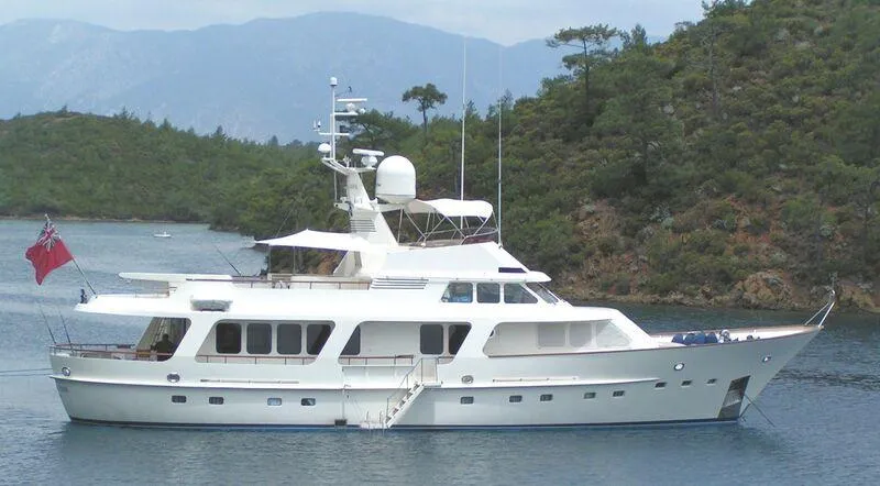  Yacht Photos Pics Luxury 1989 Moonen 85 yacht anchored in scenic bay with lush greenery.