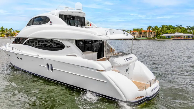 Fomo2 Yacht Photos Pics Luxury 2002 Lazzara 80 Skylounge yacht cruising on a scenic waterway.